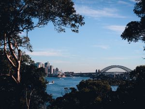 Preview wallpaper trees, buildings, city, river, boats, sky