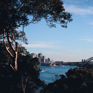 Preview wallpaper trees, buildings, city, river, boats, sky