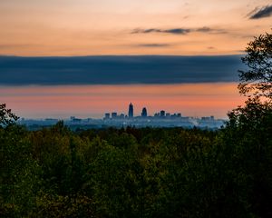 Preview wallpaper trees, city, twilight, view, tops, clouds