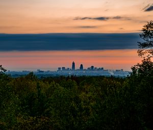 Preview wallpaper trees, city, twilight, view, tops, clouds