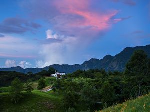 Preview wallpaper trees, hills, grass, mountains, sky, clouds, landscape