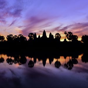 Preview wallpaper trees, reflection, silhouettes, pond, dark, evening, sky