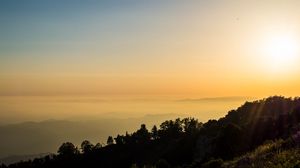 Preview wallpaper trees, slope, mountains, fog, sunset, nature