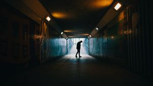Preview wallpaper tunnel, silhouette, underground, dark, loneliness