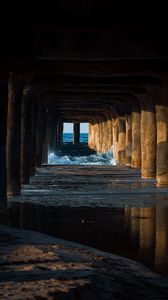 Preview wallpaper tunnel, water, waves, sand, pier