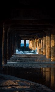 Preview wallpaper tunnel, water, waves, sand, pier