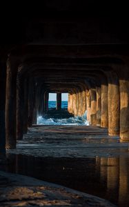 Preview wallpaper tunnel, water, waves, sand, pier