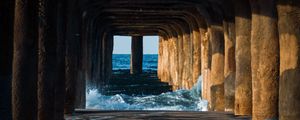 Preview wallpaper tunnel, water, waves, sand, pier