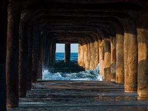Preview wallpaper tunnel, water, waves, sand, pier