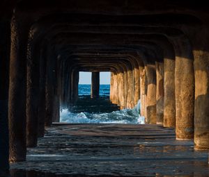 Preview wallpaper tunnel, water, waves, sand, pier