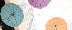 Preview wallpaper umbrellas, colorful, plane, buildings