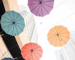 Preview wallpaper umbrellas, colorful, plane, buildings