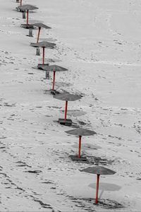 Preview wallpaper umbrellas, winter, snow, beach, landscape, red, bw