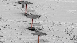 Preview wallpaper umbrellas, winter, snow, beach, landscape, red, bw