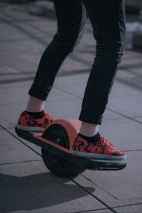 Preview wallpaper unicycle, legs, sneakers, road