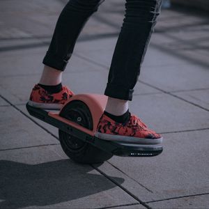 Preview wallpaper unicycle, legs, sneakers, road