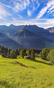 Preview wallpaper valley, grass, trees, mountains, sunlight, landscape