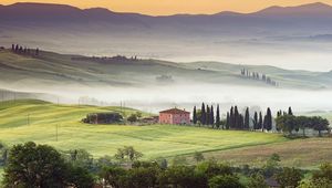 Preview wallpaper valley, home, fog, slopes, plain, trees, mountains