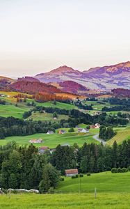 Preview wallpaper valley, trees, grass, houses, mountains