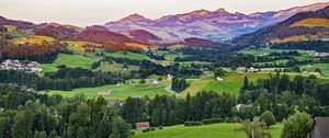 Preview wallpaper valley, trees, grass, houses, mountains