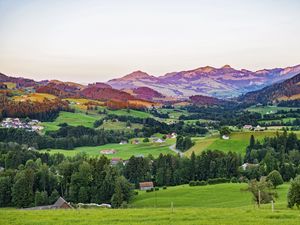 Preview wallpaper valley, trees, grass, houses, mountains