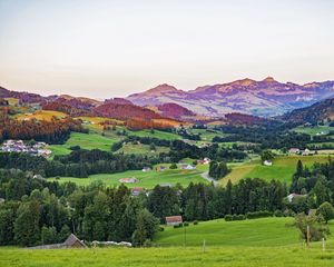 Preview wallpaper valley, trees, grass, houses, mountains