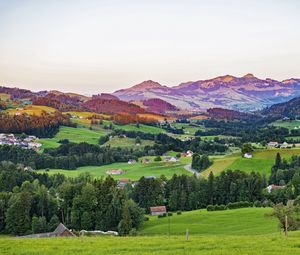 Preview wallpaper valley, trees, grass, houses, mountains