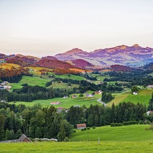 Preview wallpaper valley, trees, grass, houses, mountains