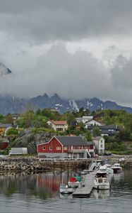 Preview wallpaper village, buildings, coast, water, mountains, clouds