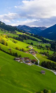 Preview wallpaper village, field, slope, grass, sky