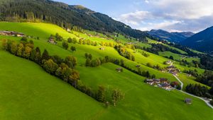 Preview wallpaper village, field, slope, grass, sky