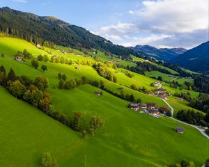 Preview wallpaper village, field, slope, grass, sky