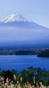 Preview wallpaper volcano, clouds, coast, top, city, water, grass