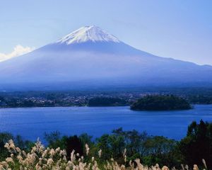 Preview wallpaper volcano, clouds, coast, top, city, water, grass