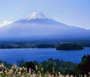 Preview wallpaper volcano, clouds, coast, top, city, water, grass