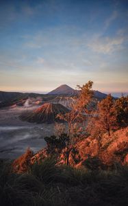 Preview wallpaper volcano, mountains, dawn, sunrise, grass, sky