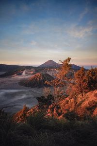 Preview wallpaper volcano, mountains, dawn, sunrise, grass, sky