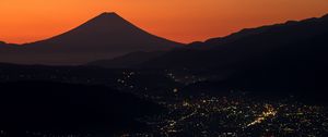 Preview wallpaper volcano, mountains, hills, lights, evening