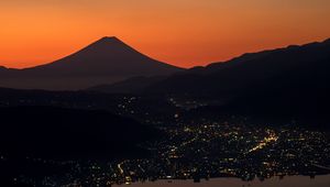 Preview wallpaper volcano, mountains, hills, lights, evening