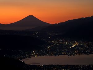 Preview wallpaper volcano, mountains, hills, lights, evening