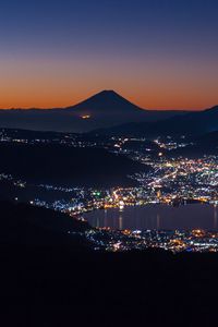 Preview wallpaper volcano, mountains, silhouettes, lights, bay, city, night