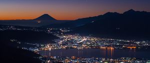 Preview wallpaper volcano, mountains, silhouettes, lights, bay, city, night