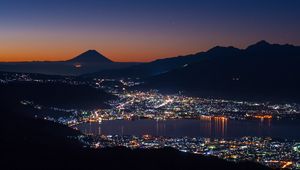 Preview wallpaper volcano, mountains, silhouettes, lights, bay, city, night