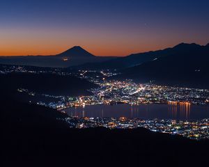 Preview wallpaper volcano, mountains, silhouettes, lights, bay, city, night