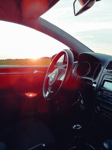 Preview wallpaper volkswagen, salon, steering, car, sunset, glare