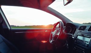 Preview wallpaper volkswagen, salon, steering, car, sunset, glare