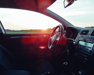 Preview wallpaper volkswagen, salon, steering, car, sunset, glare