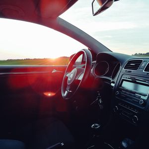 Preview wallpaper volkswagen, salon, steering, car, sunset, glare
