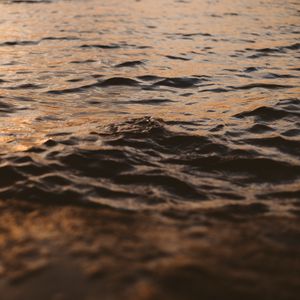 Preview wallpaper water, glare, waves, wavy, ripples, sunset