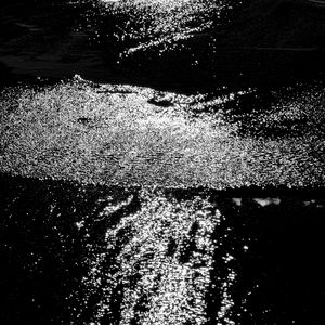 Preview wallpaper water, sea, ripples, glare, bw, dark